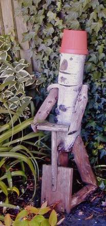 A wooden sculpture of a man with a spade
